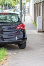 Badly parked car with tire on pavement shows wheel on walkway as traffic violation with penalty for poor driving and parking viola Royalty Free Stock Photo