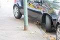 Badly parked car with tire on pavement shows wheel on walkway as traffic violation with penalty for poor driving and parking viola Royalty Free Stock Photo