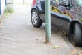 Badly parked car with tire on pavement shows wheel on walkway as traffic violation with penalty for poor driving and parking viola Royalty Free Stock Photo