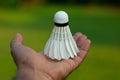 Badminton athlete's hand holding shuttlecock