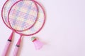 Badminton equipment. Badminton rackets and shuttlecock on pink background. Top view, copy space Royalty Free Stock Photo