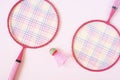 Badminton equipment. Badminton rackets and shuttlecock on pink background. Top view, copy space Royalty Free Stock Photo