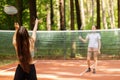 Badminton match, players play with rackets and shuttlecock on badminton court Royalty Free Stock Photo