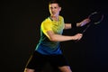 Badminton player in sportswear with racket and shuttlecock on black background. Olympic game. Royalty Free Stock Photo