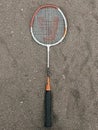 A badminton racket on the sand