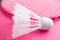 Badminton racket and shuttlecock on a bright pink background. Royalty Free Stock Photo