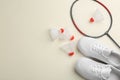 Badminton racket, shuttlecocks and shoes on light background, flat lay. Space for text Royalty Free Stock Photo