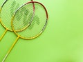 Badminton racket and White Feather Shuttlecock with a colour green background stock isolated image.