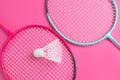 Badminton rackets on a bright pink background. Royalty Free Stock Photo