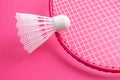 Badminton rackets and shuttlecock on a bright pink background. Royalty Free Stock Photo