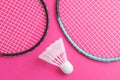 Badminton rackets and shuttlecock on a bright pink background. Royalty Free Stock Photo