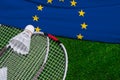 Badminton rackets and shuttlecock with flag of European union on green grass. Badminton championship in European union