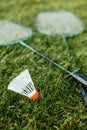 badminton rackets and shuttlecock on grass