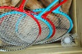 Four badminton rackets in a box with croquet mallets and a shuttlecock Royalty Free Stock Photo
