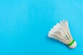 Badminton shuttlecock or birdie on a solid bright blue flat lay background symbolizing sports and activity with copy space Royalty Free Stock Photo