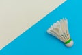 Badminton shuttlecock or birdie on a solid bright blue and white flat lay background symbolizing sports and activity with copy Royalty Free Stock Photo