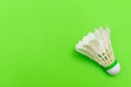 Badminton shuttlecock or birdie on a solid bright green flat lay background symbolizing sports and activity with copy space Royalty Free Stock Photo