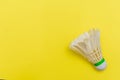 Badminton shuttlecock or birdie on a solid bright yellow flat lay background symbolizing sports and activity with copy space Royalty Free Stock Photo