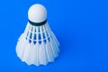 Badminton shuttlecock on blue background Royalty Free Stock Photo