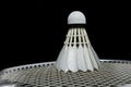Badminton shuttlecock and racket on grass and black background Royalty Free Stock Photo