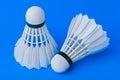 Badminton shuttlecocks on blue background Royalty Free Stock Photo