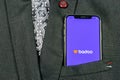 Badoo application icon on Apple iPhone X screen close-up in jacket pocket. Badoo app icon. Badoo is an online social media network