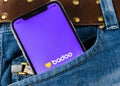 Badoo application icon on Apple iPhone X screen close-up in jeans pocket. Badoo app icon. Badoo is an online social media network.