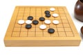 Baduk GO Stone on small wooden board plaing in the game