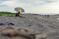 BADUNG,BALI/INDONESIA-APRIL 02 2019: Old man sits on the sand and enjoy sunbathing Royalty Free Stock Photo