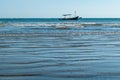 Badung - A boat drifting on the wavy sea Royalty Free Stock Photo