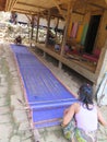 BADUY VILLAGE/INDONESIA - SEPTEMBER 27, 2014: Baduy women weaving traditional cloth using vintage loom