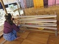 BADUY VILLAGE/INDONESIA - SEPTEMBER 27, 2014: Baduy women weaving traditional cloth using vintage loom