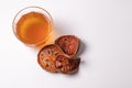 Bael fruit juice and dried quince on a white background
