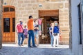Baeza, Jaen, Spain - June 20, 2020: A group of unknown tourists with a professional tourist guide visiting the old city of Baeza