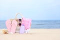 Bag with beach objects on sand, space for text Royalty Free Stock Photo