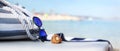 Bag on the beach with sunglasses, shells and towel Royalty Free Stock Photo