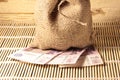 A bag of burlap is worth Russian money. Paper money on the bamboo