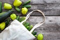 Bag canvas fabric white for mockup blank template on wooden background with vegetebles inside: cucumbers, bell pepper, zukini. Royalty Free Stock Photo