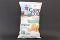 Bag of Cape Cod kettle cooked potato chips isolated against dark background.