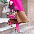 Bag close-up in female hands. Stylish modern and feminine image, style. Girl in pink tights Royalty Free Stock Photo