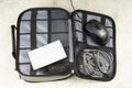 Bag with computer mouse, power outlet socket, plugs, USB cables and LED light, electronics for traveling, packing for trip Royalty Free Stock Photo
