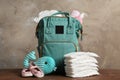 Bag with diapers and baby accessories on table Royalty Free Stock Photo