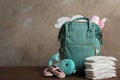 Bag with diapers and baby accessories on table. Space for text Royalty Free Stock Photo