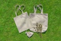 Bag from eco material Ã¢â¬â unbleached cotton. Shopper feedbag on green grass. Plastic free natural fabric