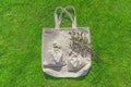 Bag from eco material Ã¢â¬â unbleached cotton. Shopper feedbag on green grass. Plastic free natural fabric