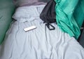 Bag fabric black and cell phone on white bed in Interior train with copy space add text