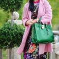 Bag in female hands closeup. Sunglasses in the hands woman. Fashion ladies accessories, bracelets, eyeglasses.