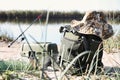 Bag with fishing essentials at riverside Royalty Free Stock Photo