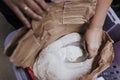 Bag of flour and female hand with scoop. close up view. bakery concept