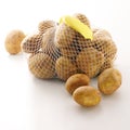 Bag of fresh potatoes with price tag on white back Royalty Free Stock Photo